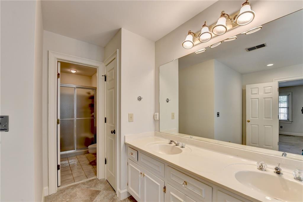 2859 Village Court Gainesville, GA 30506 - Photo 17 of 27 a bathroom with a double vanity sink and a mirror