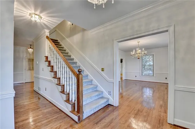 a view of entryway and hall with wooden floor