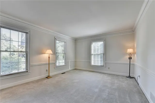 a kitchen with stainless steel appliances granite countertop a sink dishwasher stove and white cabinets with wooden floor