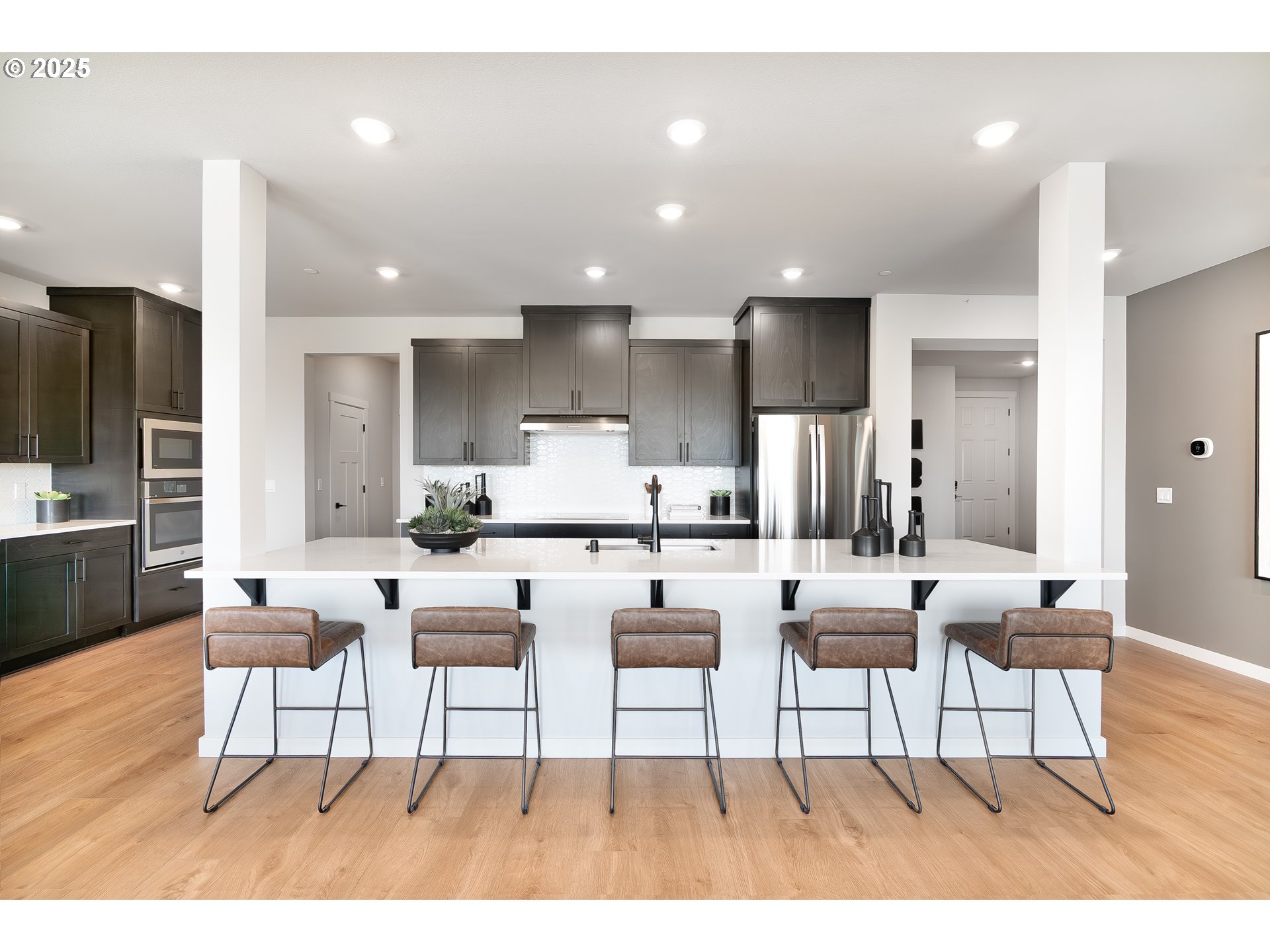 Undisclosed Address Camas, WA 98607 - Photo 29 of 48 a living room with stainless steel appliances kitchen island granite countertop furniture and a wooden floor