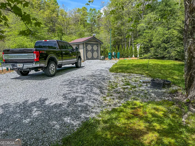 a view of a house with a car parked in it