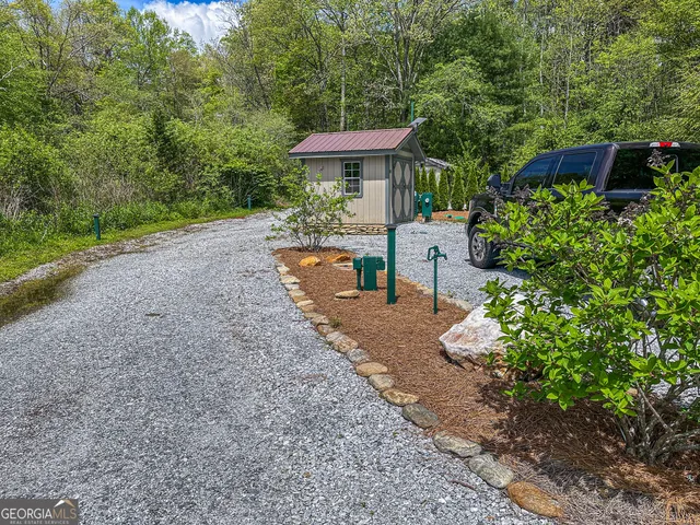 a view of a patio with furniture and a garden