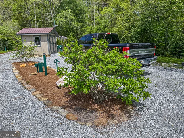 a view of a garden with wooden benches