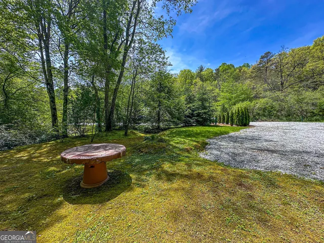 a view of a fountain with wooden fence