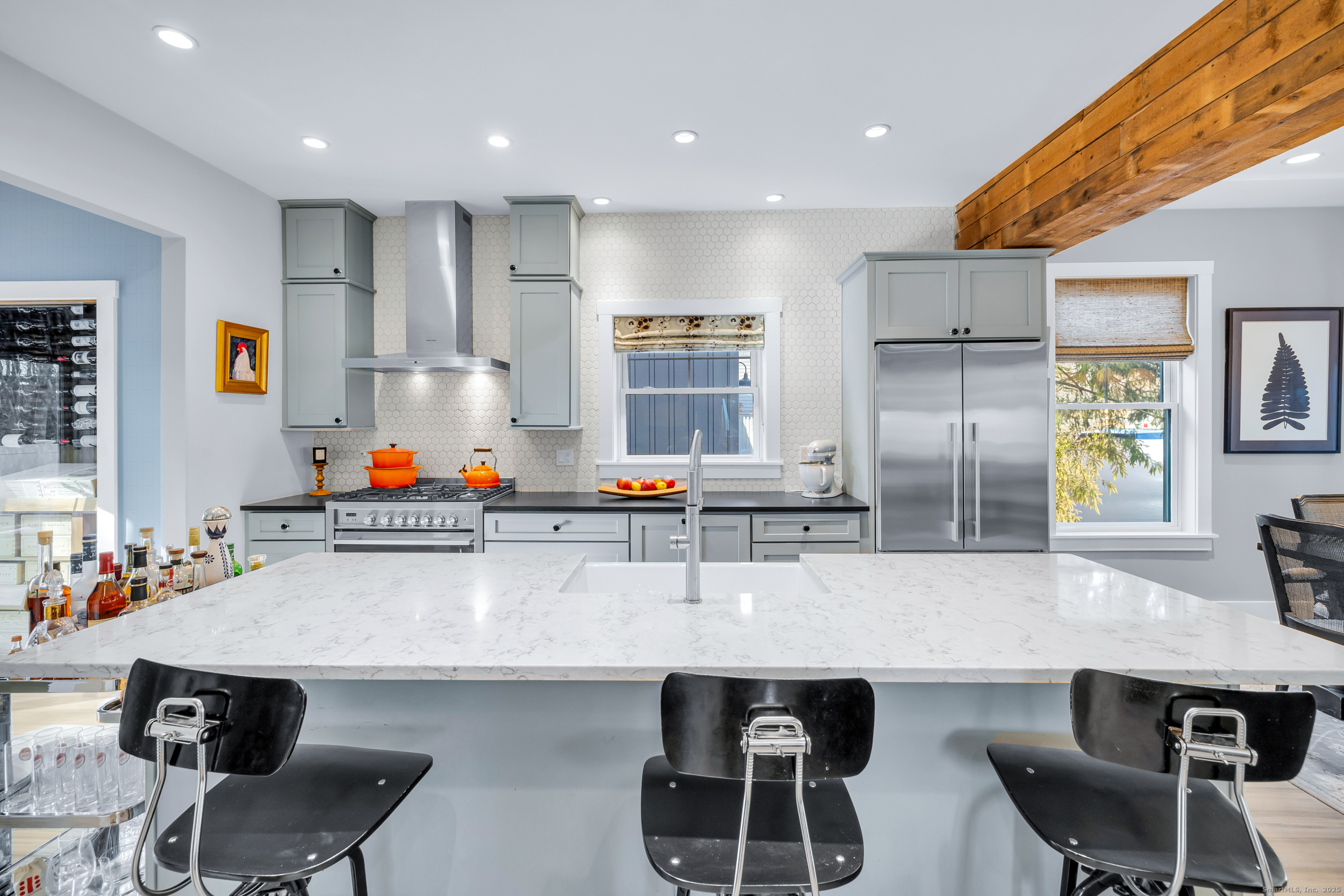 285 Old Whitfield Street Guilford, CT 06437 - Photo 10 of 40 A designer-tiled backsplash adds style, while the island offers additional seating and extra storage space.