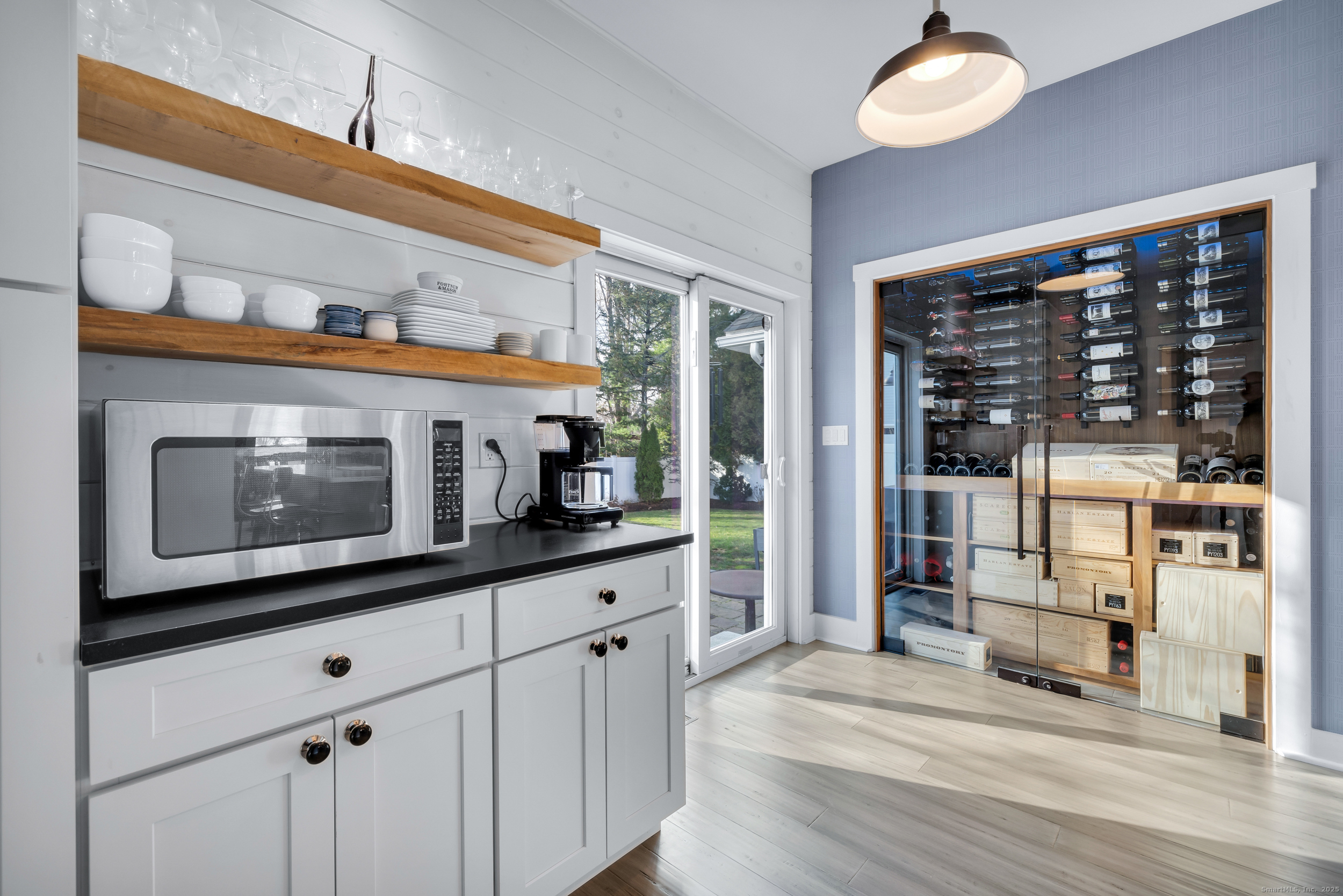 285 Old Whitfield Street Guilford, CT 06437 - Photo 12 of 40 The breakfast/dry bar showcases floating shelves, custom cabinetry, and a shiplap wall. The wine enthusiast will love the custom designed wine cellar. Glass slider provides access to the fully fenced backyard.