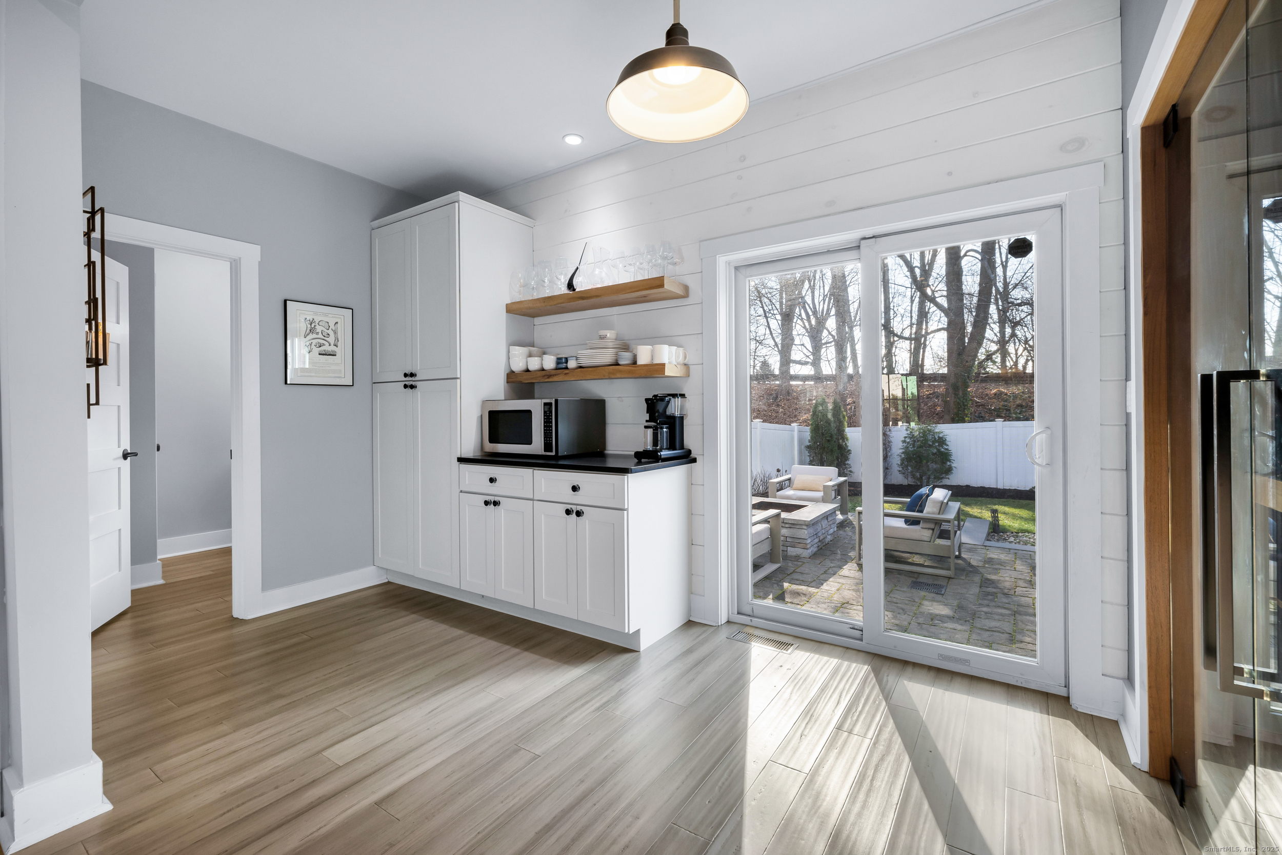 285 Old Whitfield Street Guilford, CT 06437 - Photo 13 of 40 Slider opens to a stone patio with a built-in fire pit, a level yard, and privacy fencing. Convenient access to the 2-car garage and driveway gate.