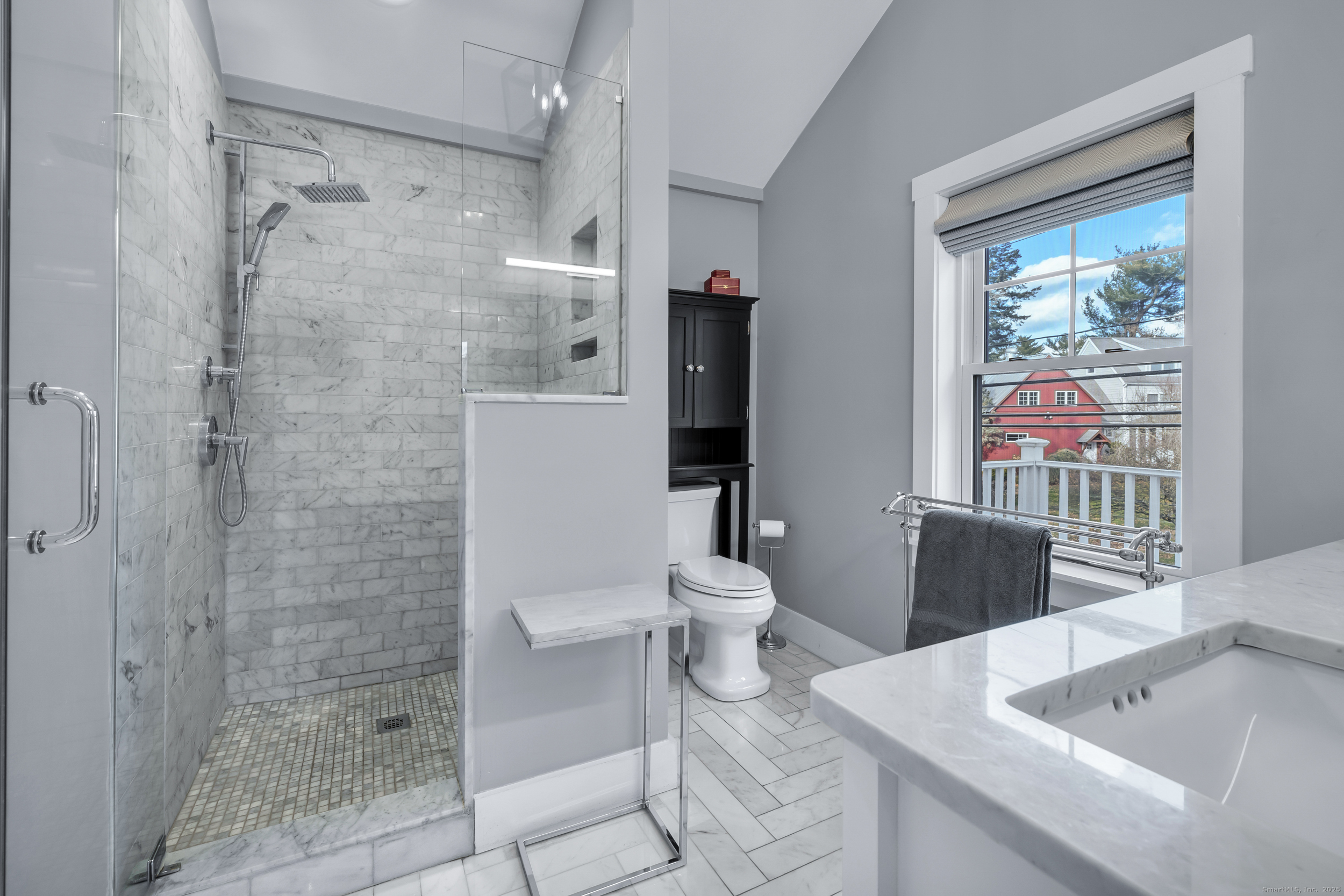 285 Old Whitfield Street Guilford, CT 06437 - Photo 18 of 40 The master bath offers elegant tile floors, a dual-sink vanity, and a walk-in shower with marble surround and glass enclosure.