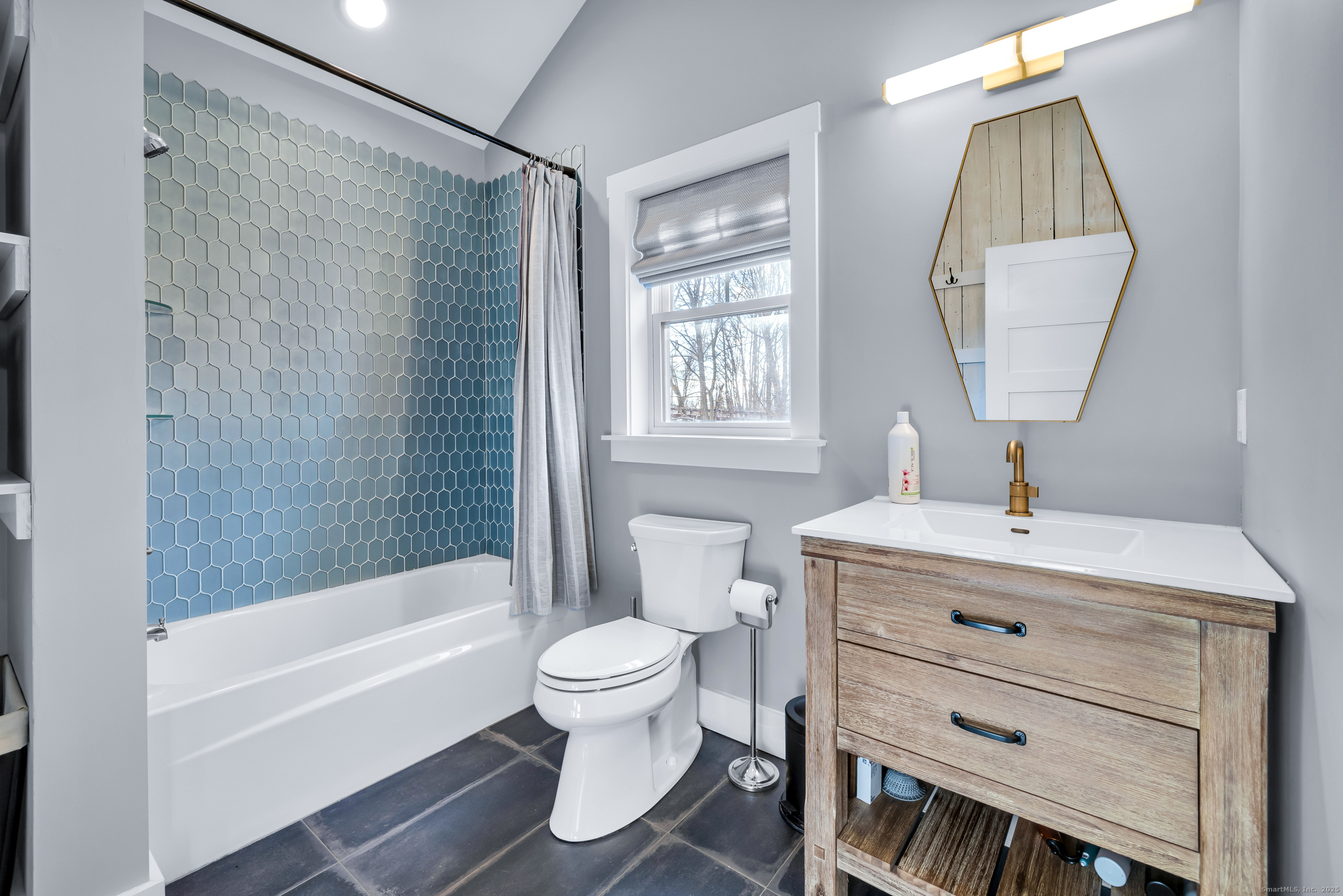 285 Old Whitfield Street Guilford, CT 06437 - Photo 22 of 40 A second full bath serves the secondary bedrooms and features a tile floor, combination tub/shower, and open shelving for convenient storage