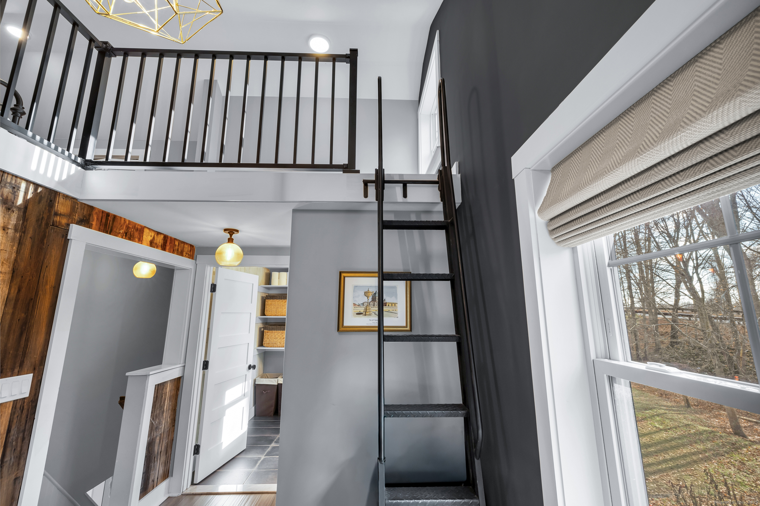 285 Old Whitfield Street Guilford, CT 06437 - Photo 26 of 40 Ladder in office leads to the upper level loft. NOTE: the space behind ladder wall houses the washer and dryer.