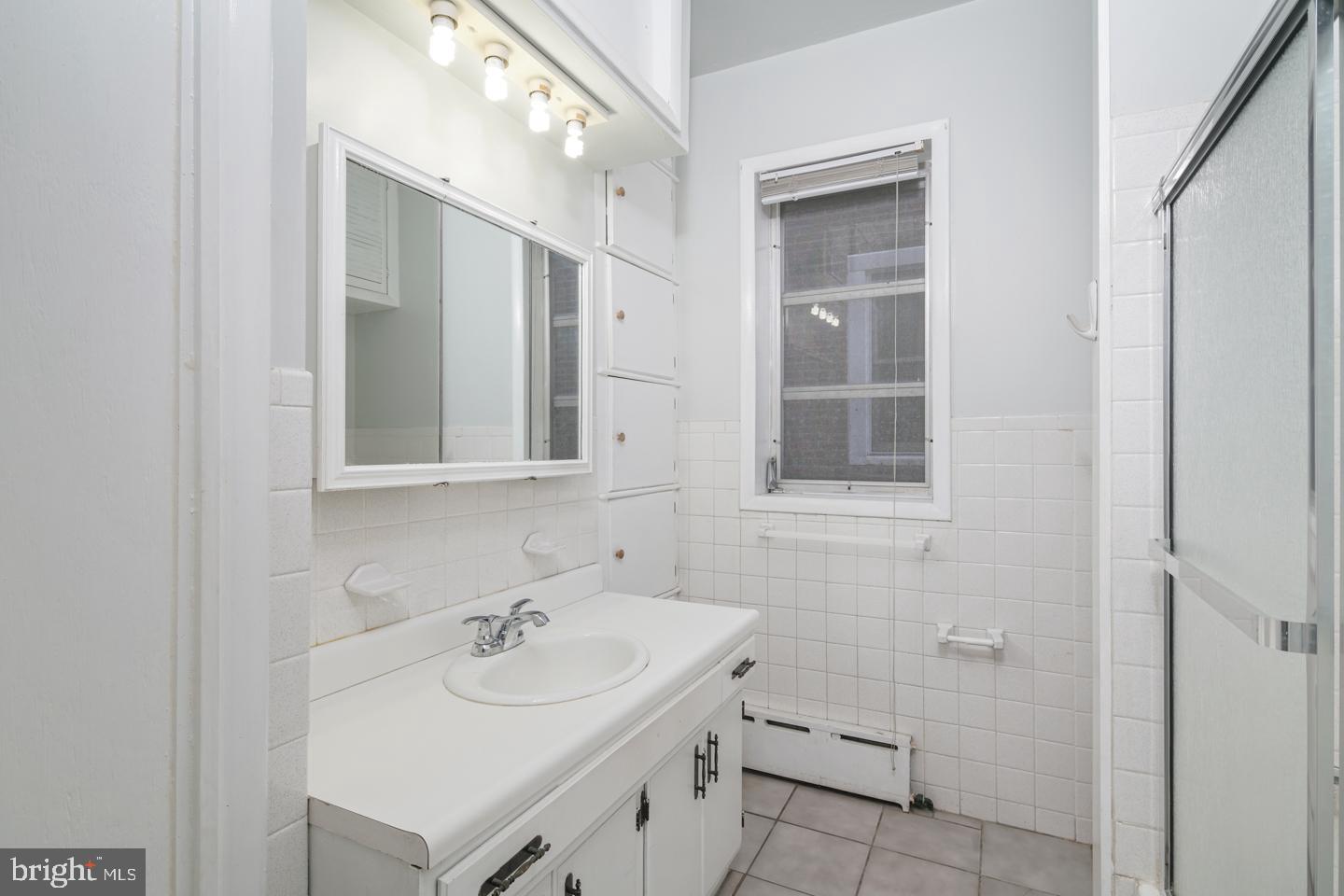 2324 Poplar Street, Unit 2F Philadelphia, PA 19130 - Photo 14 of 24 a bathroom with a sink and a mirror
