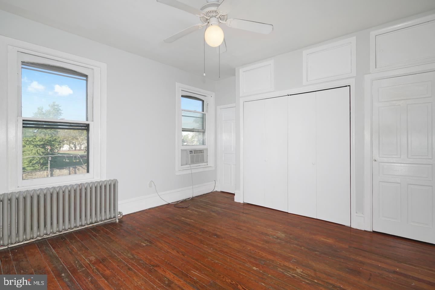 2324 Poplar Street, Unit 2F Philadelphia, PA 19130 - Photo 15 of 24 an empty room with wooden floor fan and windows