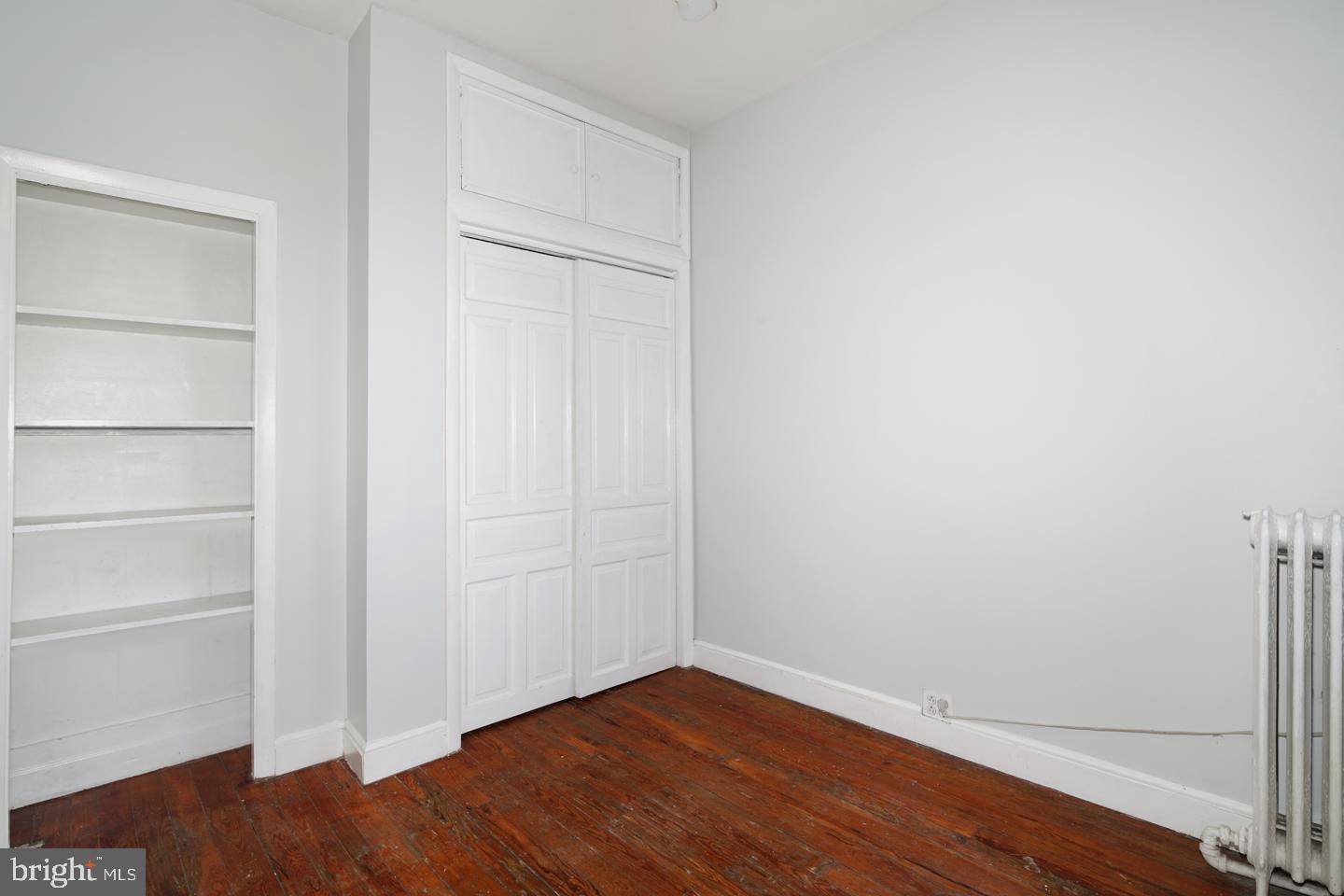 2324 Poplar Street, Unit 2F Philadelphia, PA 19130 - Photo 17 of 24 a view of an empty room with wooden floor