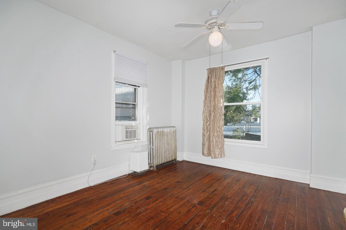 2324 Poplar Street, Unit 2F Philadelphia, PA 19130 - Photo 21 of 24 a view of an empty room with wooden floor and a window