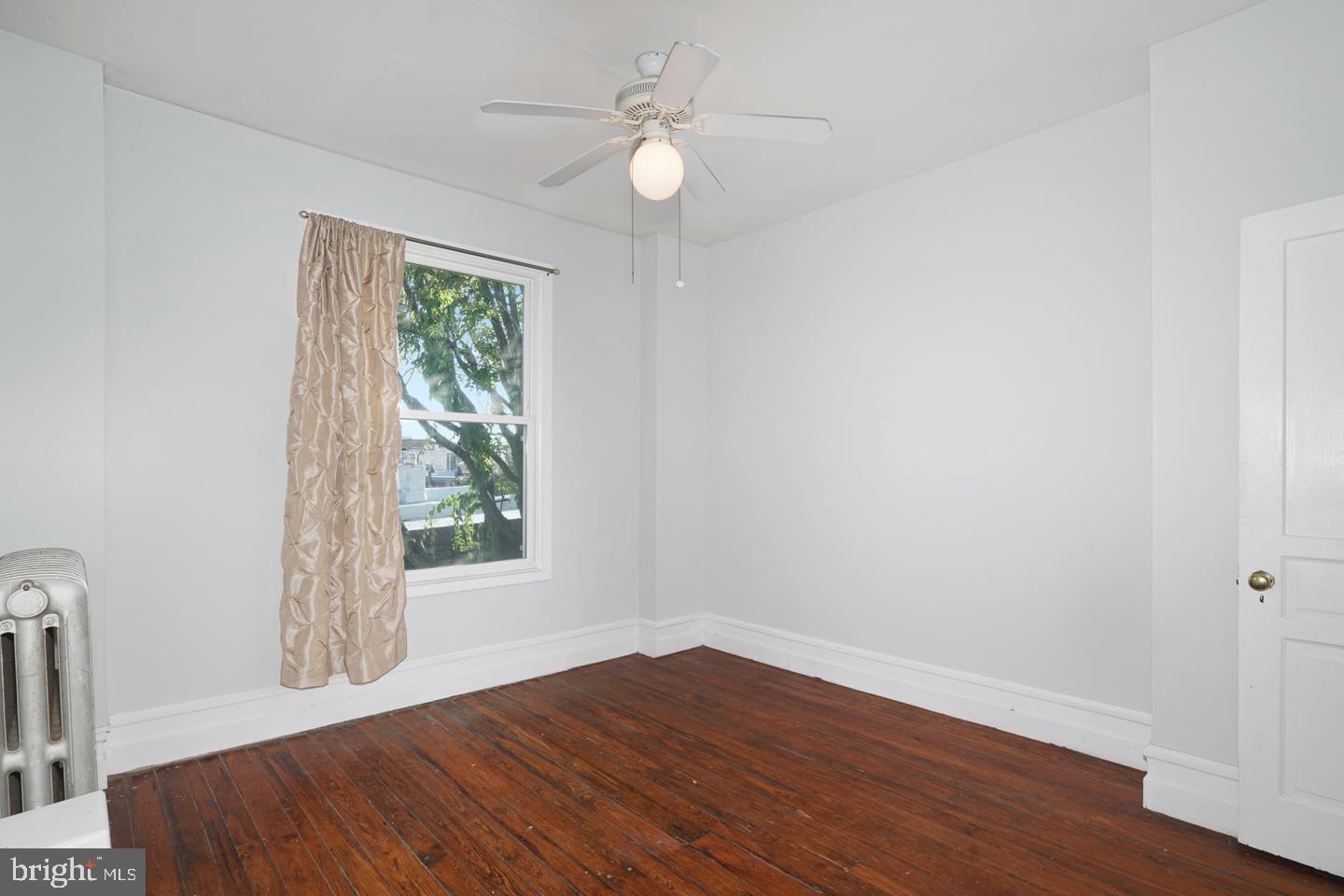 2324 Poplar Street, Unit 2F Philadelphia, PA 19130 - Photo 22 of 24 wooden floor in an empty room with a window