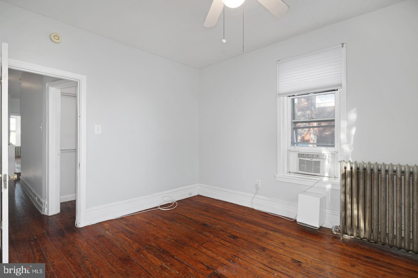 2324 Poplar Street, Unit 2F Philadelphia, PA 19130 - Photo 23 of 24 an empty room with wooden floor and windows