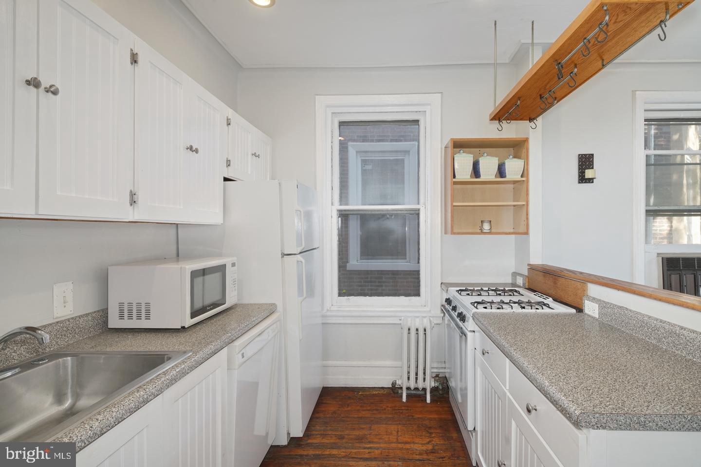 2324 Poplar Street, Unit 2F Philadelphia, PA 19130 - Photo 3 of 24 a kitchen with stainless steel appliances granite countertop a sink stove and refrigerator