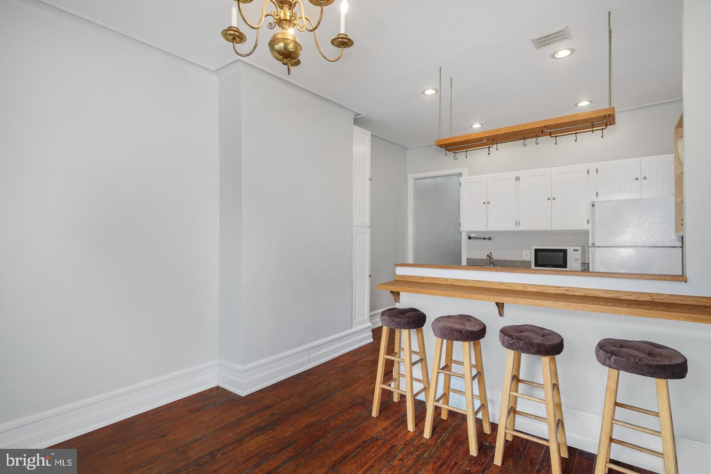2324 Poplar Street, Unit 2F Philadelphia, PA 19130 - Photo 5 of 24 a white kitchen with a table and chairs