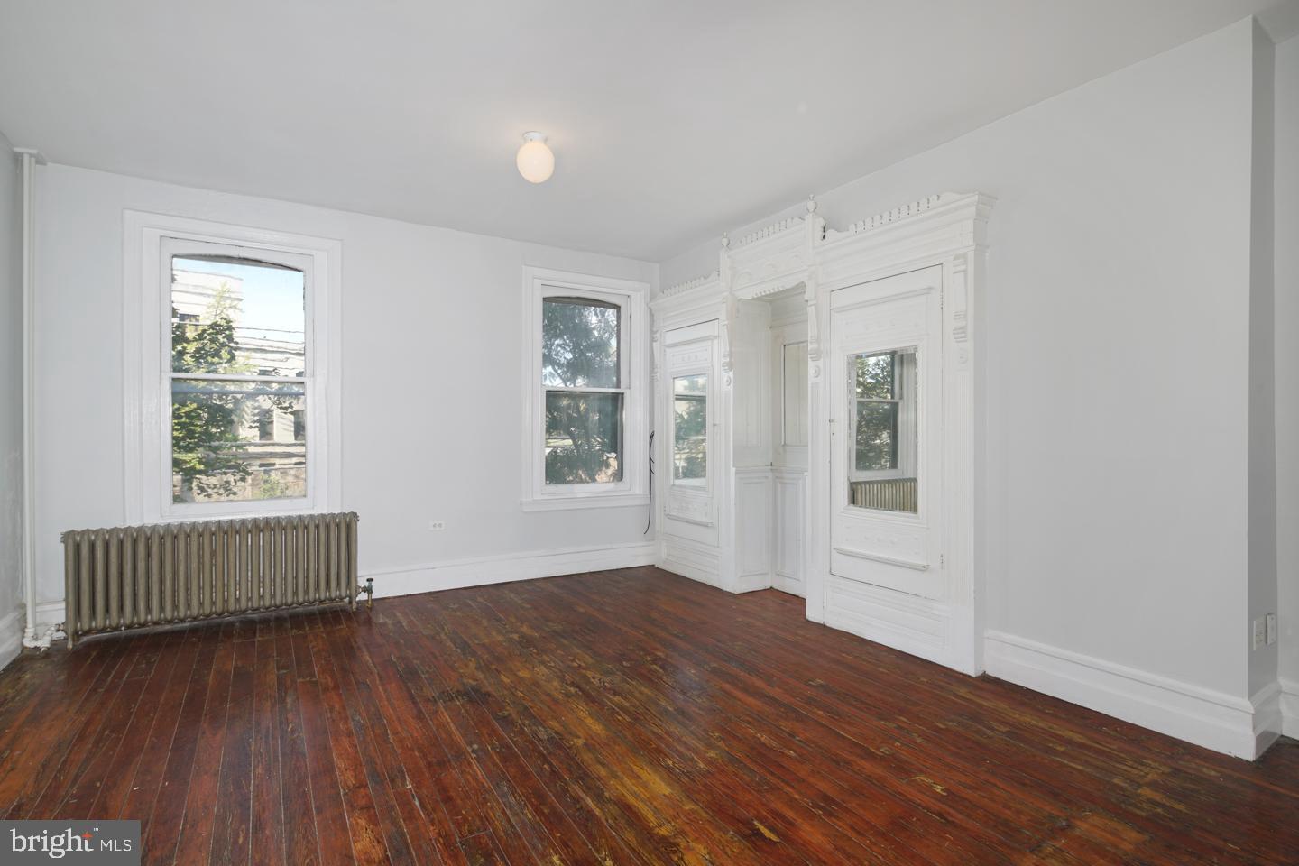 2324 Poplar Street, Unit 2F Philadelphia, PA 19130 - Photo 9 of 24 an empty room with wooden floor and windows