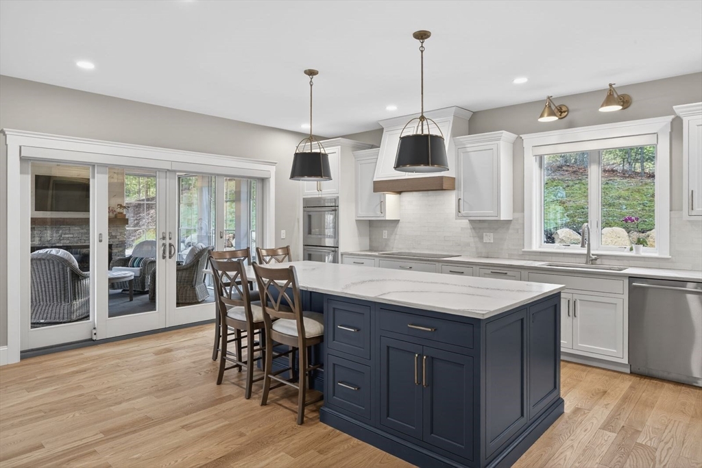 12 Talcott Pines Road Plymouth, MA 02360 - Photo 18 of 41 a kitchen with stainless steel appliances granite countertop wooden floor window and cabinets