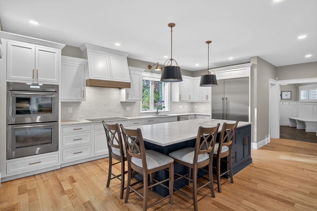 12 Talcott Pines Road Plymouth, MA 02360 - Photo 25 of 41 a kitchen with stainless steel appliances a dining table chairs and wooden floor