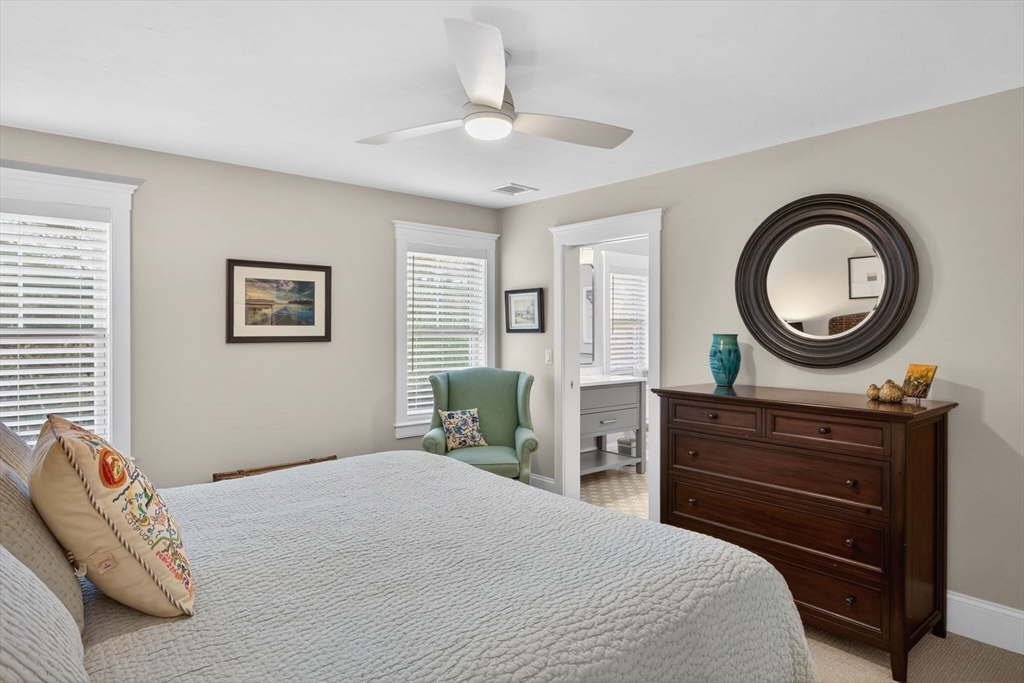 12 Talcott Pines Road Plymouth, MA 02360 - Photo 35 of 41 a bedroom with a bed and a chandelier