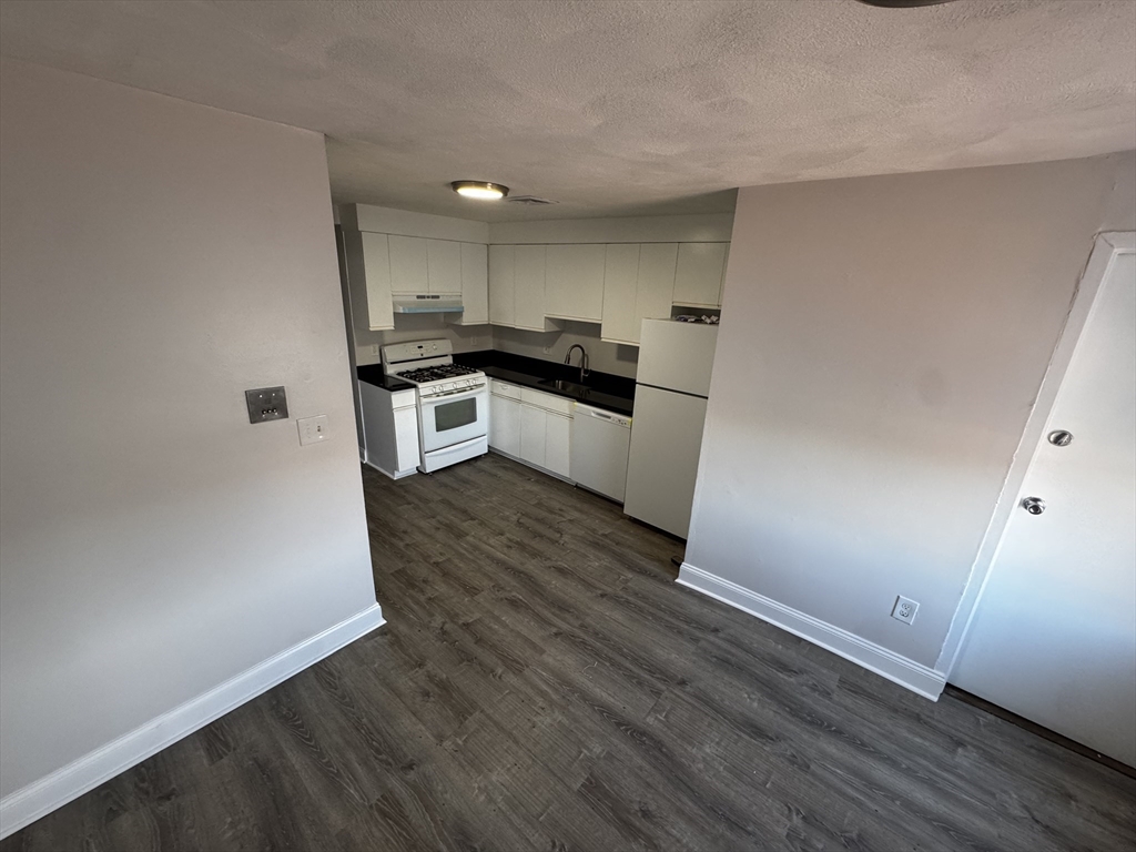 a kitchen with granite countertop a sink and steel appliances