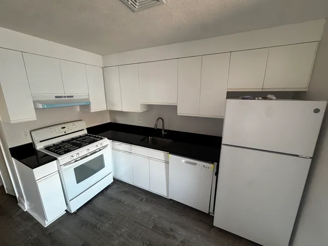 a kitchen with a sink and a refrigerator