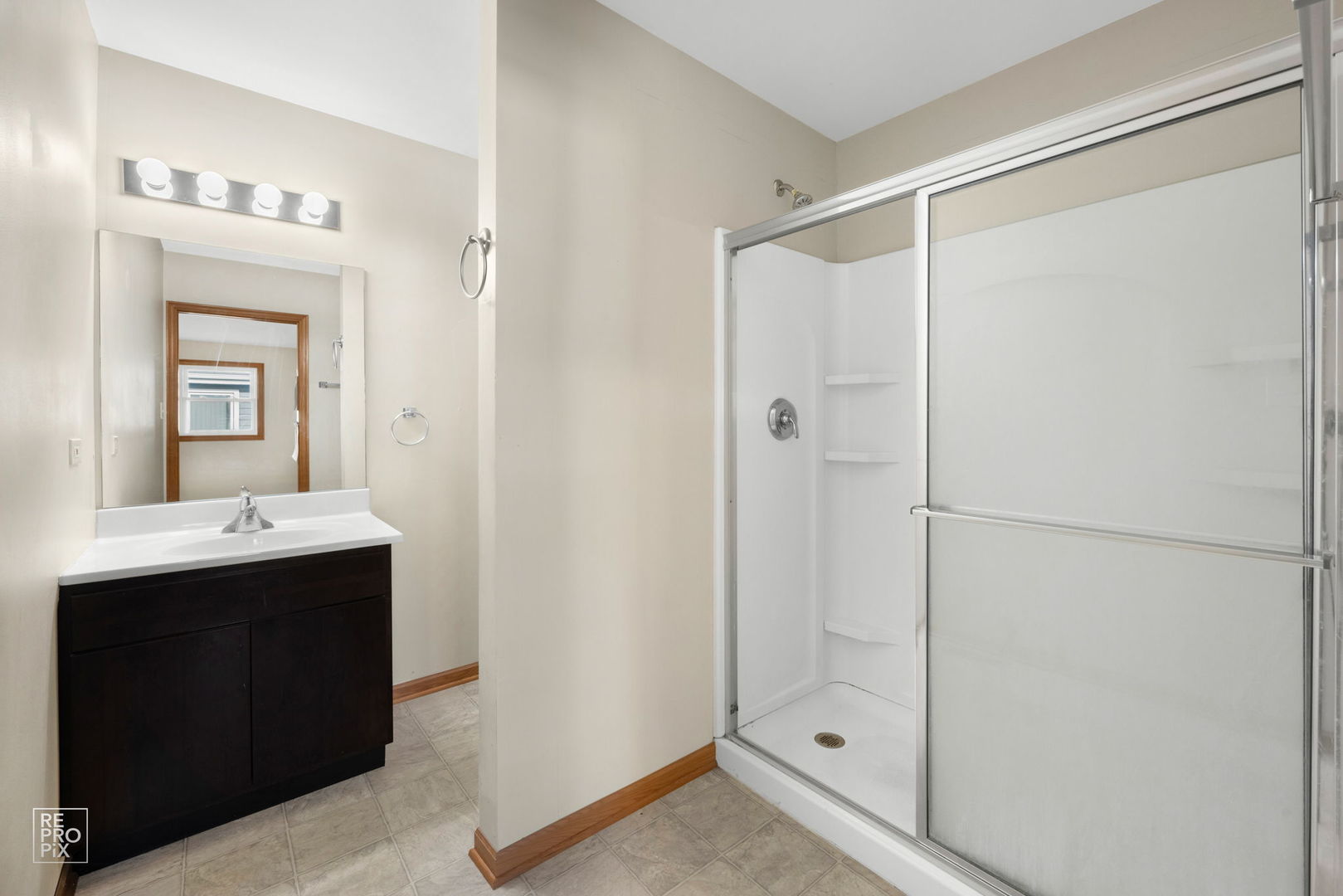 309 Wheatfield Road Matteson, IL 60443 - Photo 16 of 22 a bathroom with a shower sink and mirror