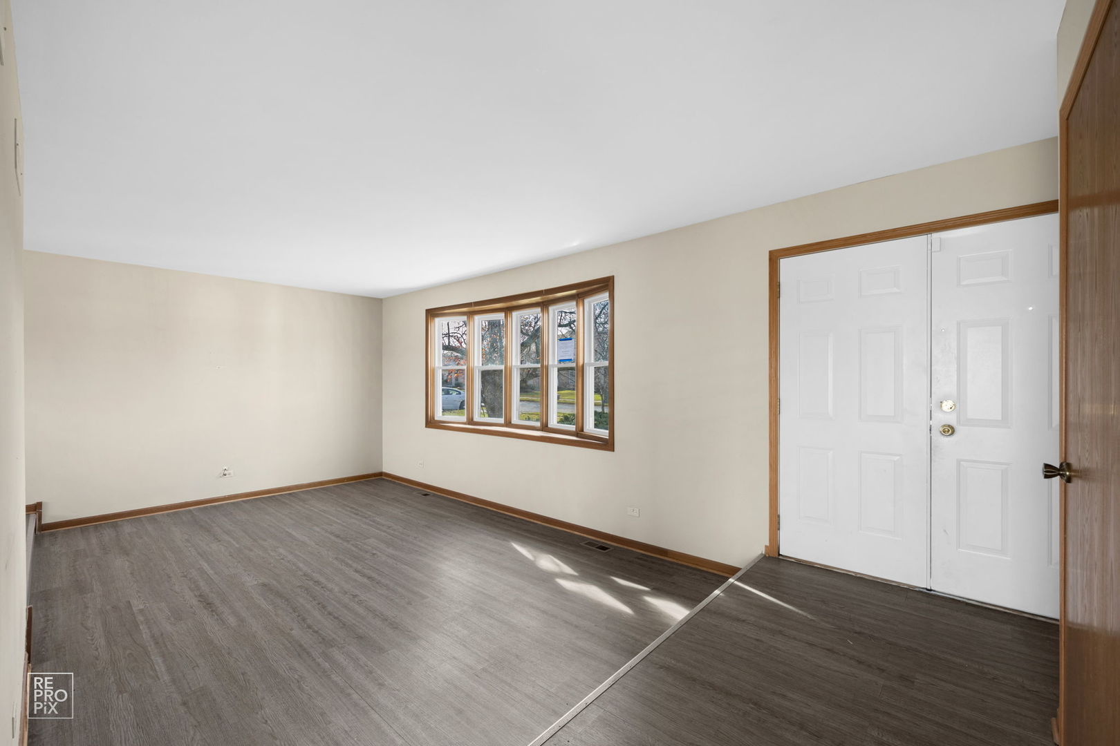 309 Wheatfield Road Matteson, IL 60443 - Photo 21 of 22 a view of an empty room with wooden floor and a window