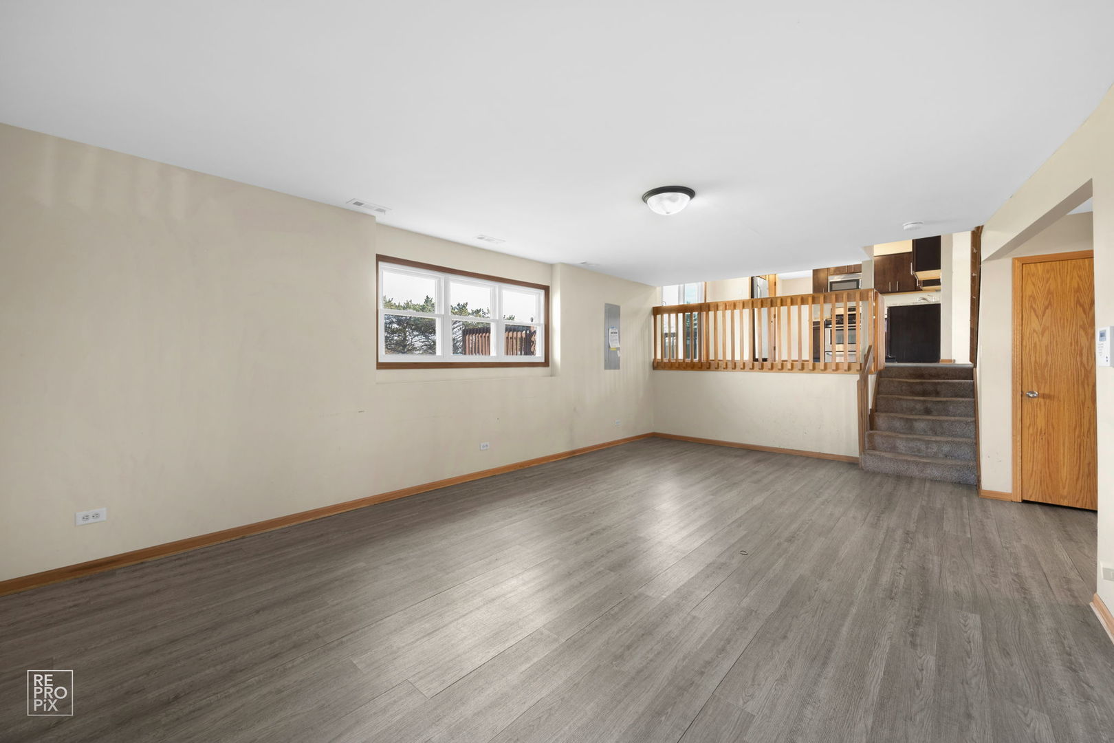 309 Wheatfield Road Matteson, IL 60443 - Photo 22 of 22 a view of an empty room with a window and wooden floor
