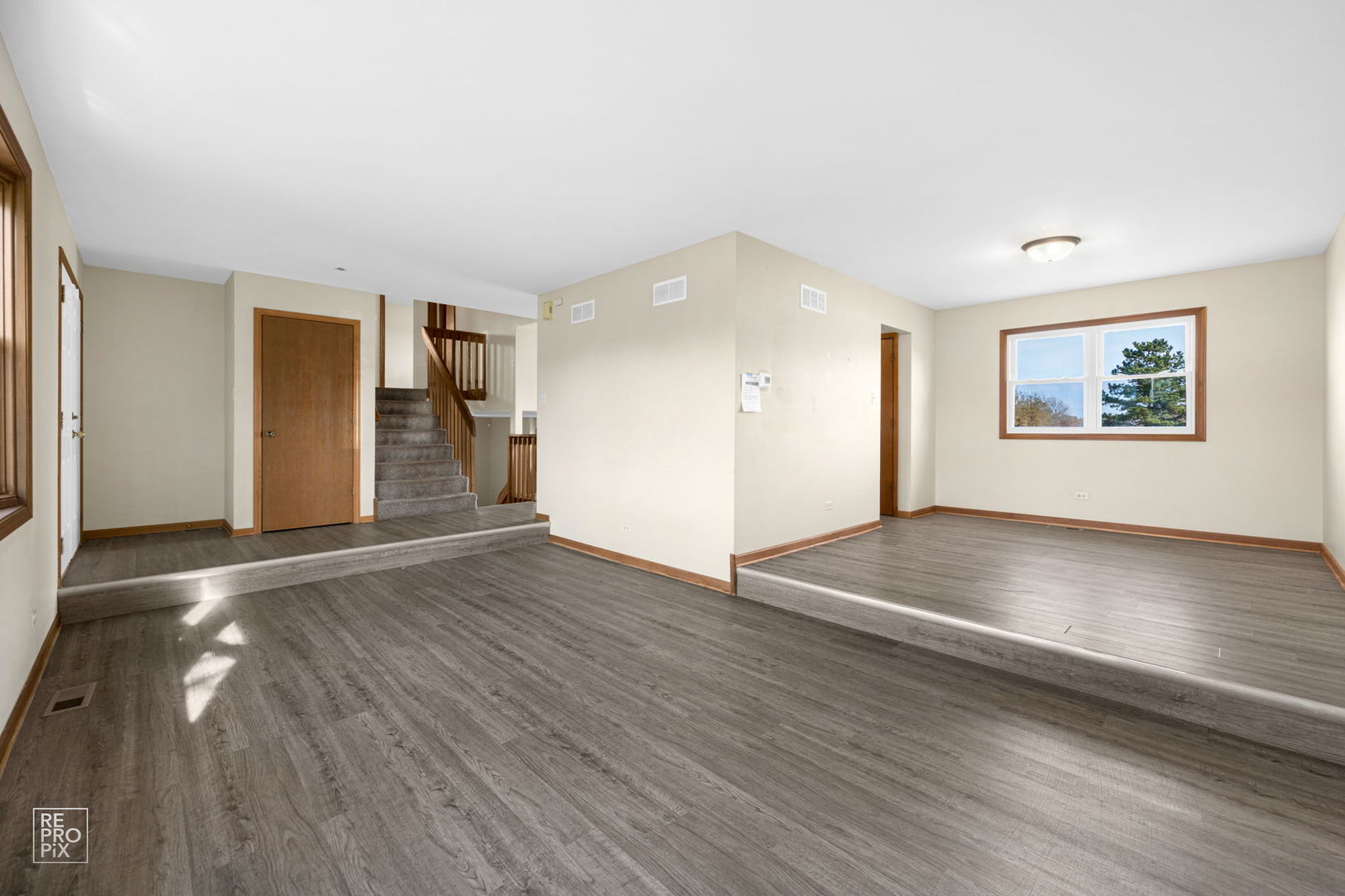 309 Wheatfield Road Matteson, IL 60443 - Photo 8 of 22 an empty room with wooden floor and windows