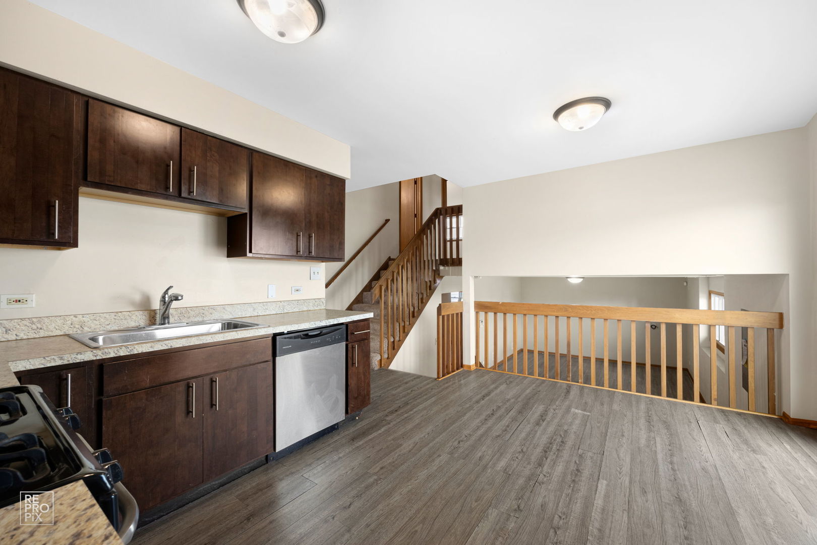 309 Wheatfield Road Matteson, IL 60443 - Photo 9 of 22 a kitchen with a sink and wooden floor