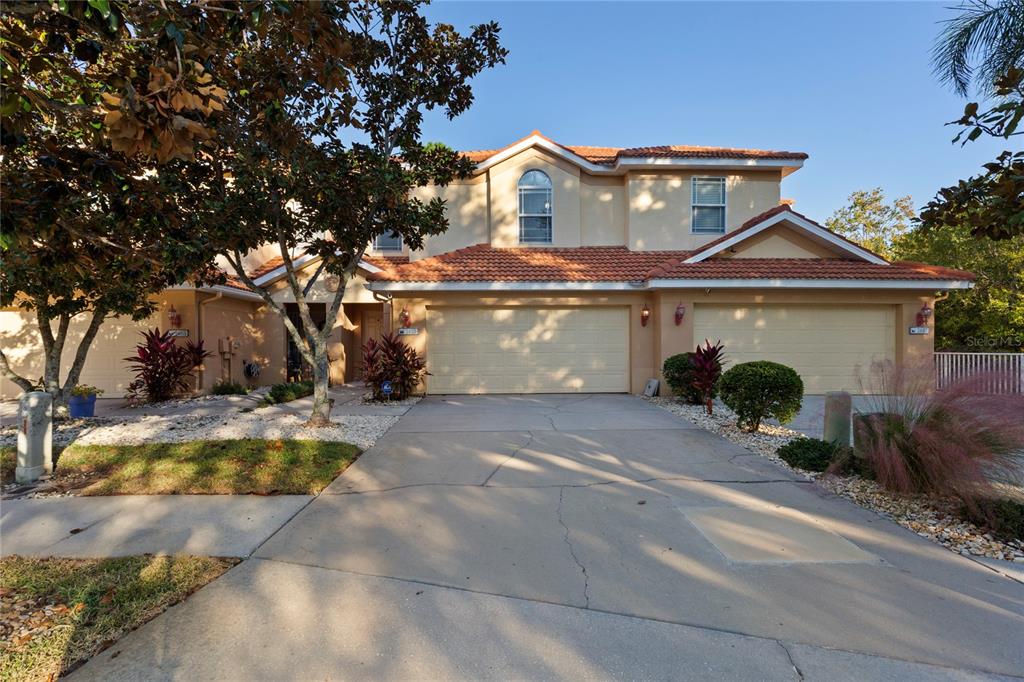 1455 Hidden Court Tarpon Springs, FL 34689 - Photo 1 of 30 a front view of a house with a yard