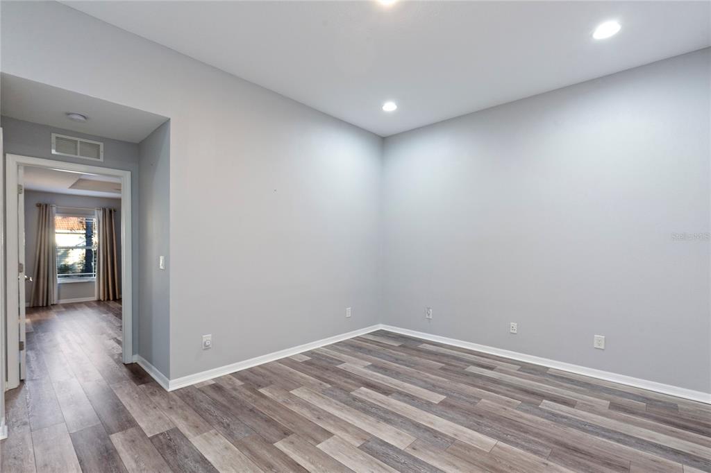 1455 Hidden Court Tarpon Springs, FL 34689 - Photo 14 of 30 a view of a room with wooden floor and a window