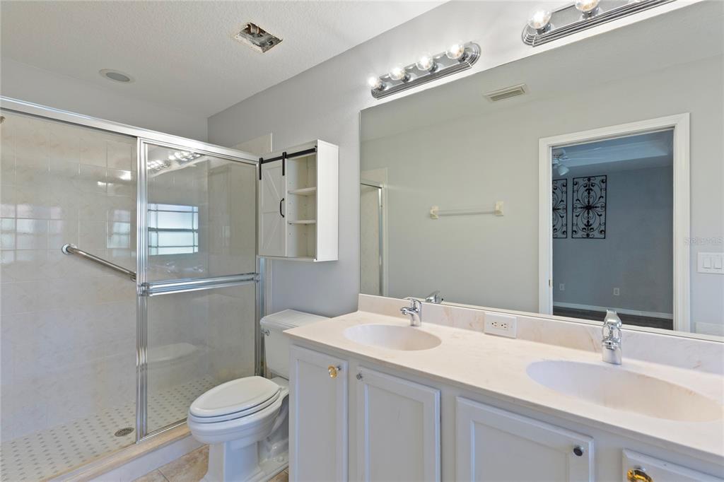 1455 Hidden Court Tarpon Springs, FL 34689 - Photo 17 of 30 a bathroom with a sink and a mirror