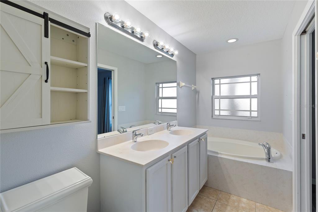 1455 Hidden Court Tarpon Springs, FL 34689 - Photo 18 of 30 a bathroom with a sink a toilet and bathtub