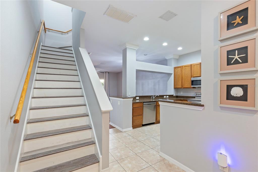 1455 Hidden Court Tarpon Springs, FL 34689 - Photo 3 of 30 a view of a kitchen with wooden floor and electronic appliances
