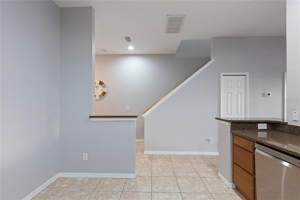 1455 Hidden Court Tarpon Springs, FL 34689 - Photo 6 of 30 a view of kitchen with granite countertop white cabinets and black appliances