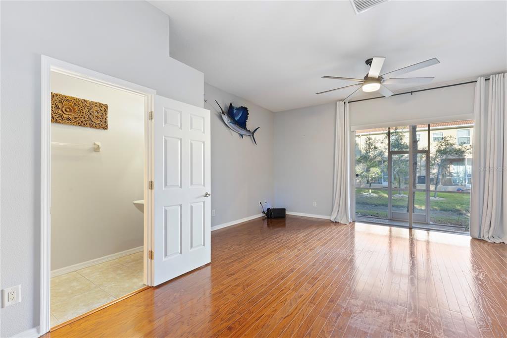 1455 Hidden Court Tarpon Springs, FL 34689 - Photo 7 of 30 wooden floor in an empty room with a window