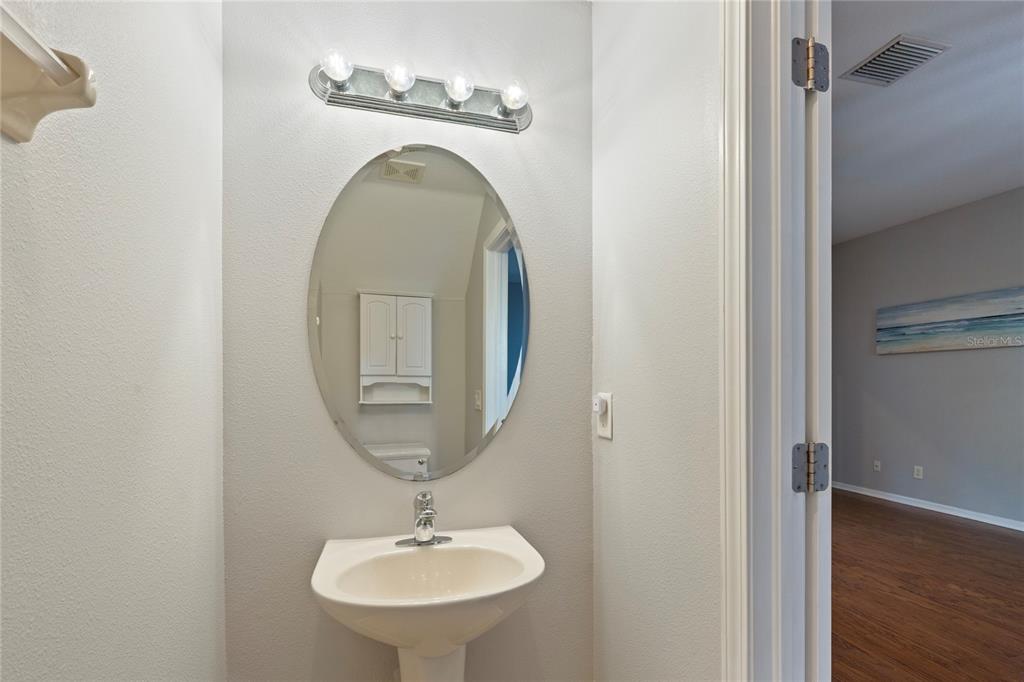 1455 Hidden Court Tarpon Springs, FL 34689 - Photo 8 of 30 a bathroom with a sink and a mirror