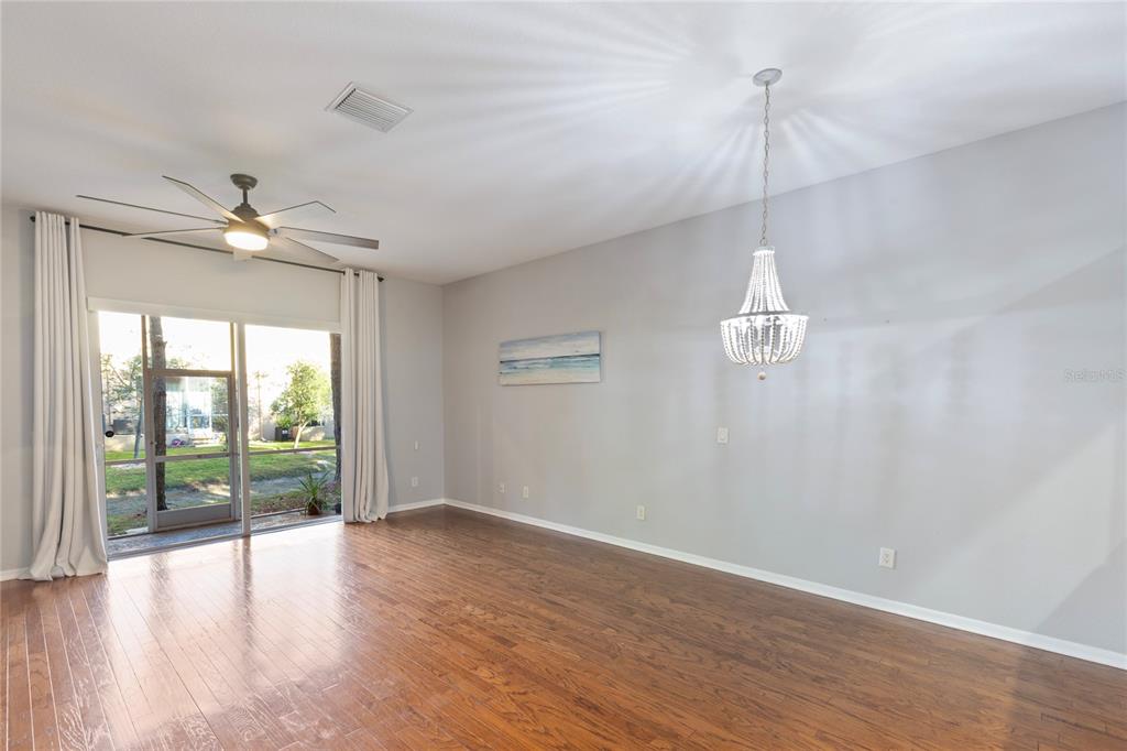 1455 Hidden Court Tarpon Springs, FL 34689 - Photo 9 of 30 a view of an empty room with a window and wooden floor