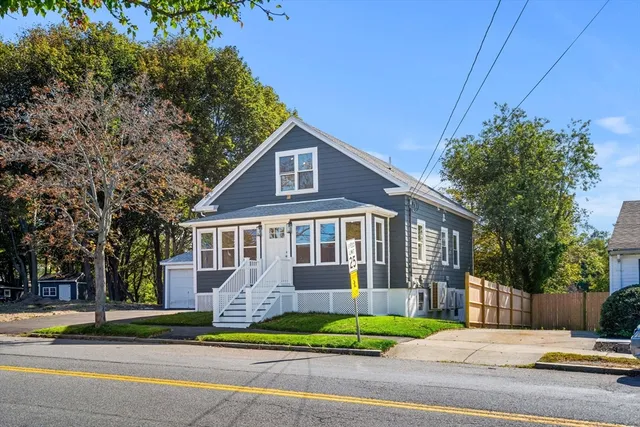a front view of a house with a garden