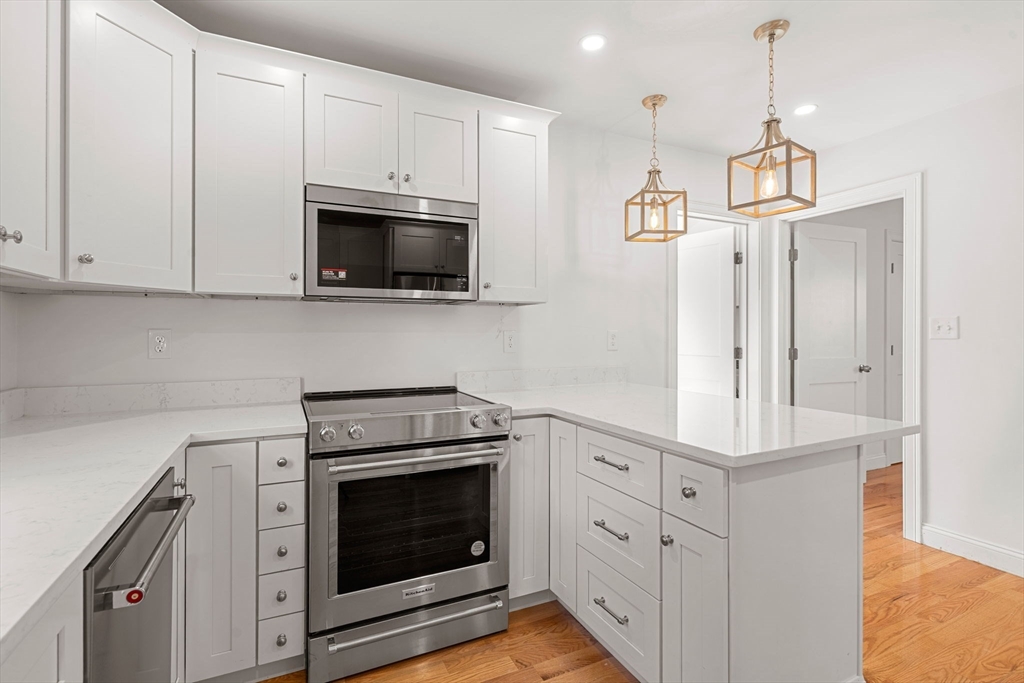 29 Willson Street Salem, MA 01970 - Photo 17 of 41 a kitchen with white cabinets and stainless steel appliances