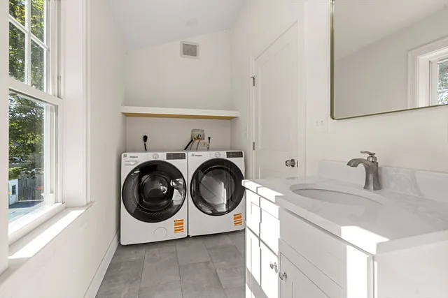 a utility room with sink dryer and washer