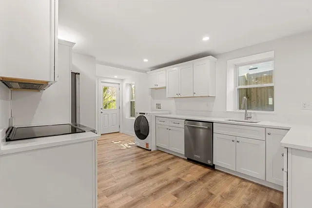 a kitchen with a stove a sink and a refrigerator