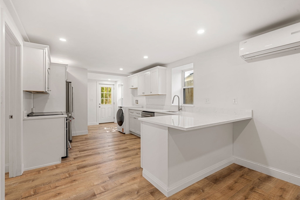 29 Willson Street Salem, MA 01970 - Photo 26 of 41 a kitchen with white cabinets and white appliances