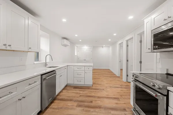 a kitchen with a sink stove and cabinets