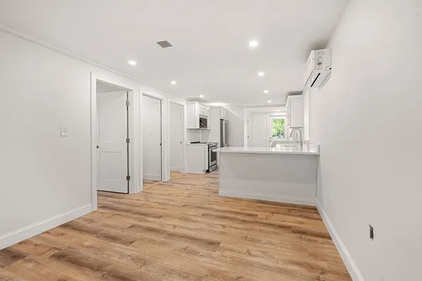 a view of a kitchen with a refrigerator and a window