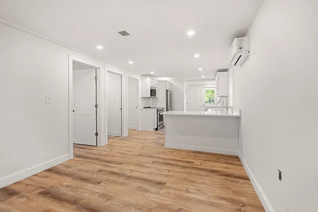 a view of a kitchen with a refrigerator and a window